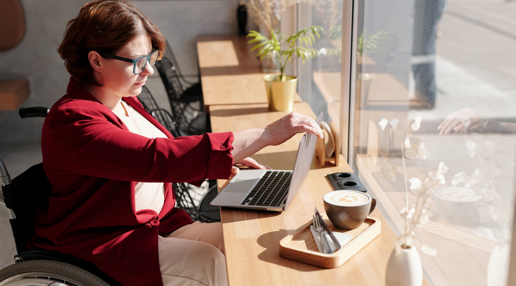 woman in wheelchair using laptop